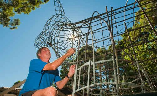 Builder gary Smith works on the big golden dog , being built for the golden dog hotel glenreigh. Builder gary Smith works on the big golden dog , being built for the golden dog hotel glenreigh.